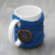 An image of a mug cozy made with Needle Crafters Acrylic Yarn, Deep Sea Blue.